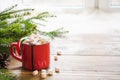 Red cup of hot chocolate with marshmallow on windowsill. Weekend concept. Home style. Christmas time. Royalty Free Stock Photo