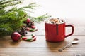 Red cup of hot chocolate with marshmallow on windowsill. Weekend concept. Home style. Christmas time. Royalty Free Stock Photo