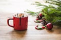 Red cup of hot chocolate with marshmallow on windowsill. Weekend concept. Home style. Christmas morning. Royalty Free Stock Photo