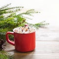 Red cup of hot chocolate with marshmallow on windowsill. Weekend concept. Home style. Christmas time. Royalty Free Stock Photo