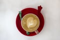 Red cup of hot coffee with heart on light background. Top view, flat lay Royalty Free Stock Photo