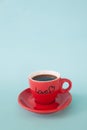 Red cup of hot coffee with LOVE word on pastel color background Royalty Free Stock Photo