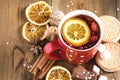 Red cup of hot tea with orange and berries Christmas winter beverage Christmas food concept Wooden background Cinnamone sticks Coo Royalty Free Stock Photo