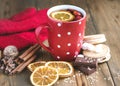 Red cup of hot tea with orange and berries Christmas winter beverage Christmas food concept Wooden background Cinnamone sticks Coo Royalty Free Stock Photo