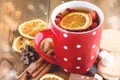 Red cup of hot tea with orange and berries Christmas winter beverage Christmas food concept Wooden background Cinnamone sticks Coo Royalty Free Stock Photo