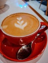 Red cup, latte art, coffee, spoon. Royalty Free Stock Photo