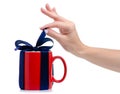 Red cup mug with blue ribbon bow gift in hand Royalty Free Stock Photo