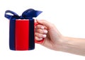 Red cup mug with blue ribbon bow gift in hand Royalty Free Stock Photo