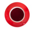 Red cup on a red saucer with red tea, isolated on a white background, top view Royalty Free Stock Photo