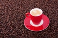 A red cup and saucer with coffee