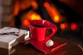 Red cup of tea or coffee, glass on the book and chocolate near f Royalty Free Stock Photo
