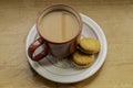 A red cup of tea and two biscuits. Royalty Free Stock Photo