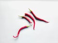 Red curly chilies white background