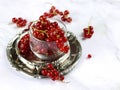 Red currant berries in a transparent bowl on a marble table, close up. Fresh red currants on light background with copy space. Royalty Free Stock Photo