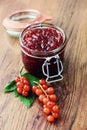 Red currant jam and ripe on wooden table Royalty Free Stock Photo