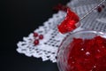 Red currant jelly in glass bowl against black background