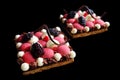 Red currant mousse and blackberry puff pastry desserts with whipped ganache and chocolate spiral decoration