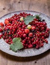 Red currant sponge cake. Plate with Assorted summer berries, raspberries, strawberries, cherries, currants, gooseberries.