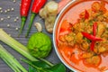 Red curry chicken, Thai Spicy food and fresh herb ingredients on wooden top view / still life, selective focus