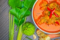 Red curry chicken, Thai Spicy food and fresh herb ingredients on wooden top view / still life, selective focus