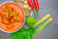 Red curry chicken, Thai Spicy food and fresh herb ingredients on wooden top view / still life, selective focus
