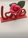 Love Sculpture with Rose Accent Royalty Free Stock Photo
