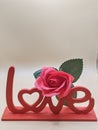Love Sculpture with Rose Accent Royalty Free Stock Photo
