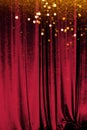 The red curtain made of luxurious velvet on the stage of the theater is fantastically glittering