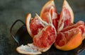 Red sliced grapefruit with skin on a metal tray Royalty Free Stock Photo