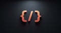 Red 3D curly brackets and a forward slash are arranged to form a code-like symbol on Royalty Free Stock Photo