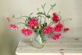 Red dahlias in a glass vase.Red dahlias in a glass vase on a table covered with a white cloth on a white background Royalty Free Stock Photo