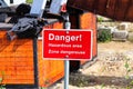 A red danger hazardous area sign in english and french