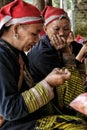 Red Dao women sewing in the village.