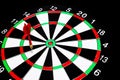 Red dart arrow failed to hit in the target center of dartboard Royalty Free Stock Photo