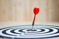 Red dart arrow hit the center target of dartboard metaphor marketing competition concept Royalty Free Stock Photo