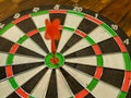 Red dart arrow hit in the target center of dartboard, winner concept, goal concept Royalty Free Stock Photo