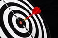 Red dart arrow hitting in the target center of dartboard Royalty Free Stock Photo