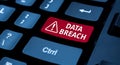 Red data breach warning symbol displayed on a computer keyboard key highlighting cyber security threats and digital risks Royalty Free Stock Photo
