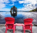 Red deck chairs set in front of Rock