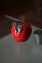 Red decorative ceramic apple on table