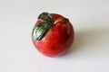 Red decorative ceramic apple on table