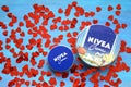 Nivea cream product and red hearts blue background Royalty Free Stock Photo