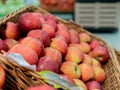 Apples in a wicker box on a grocery shelf. Close-up of fruit in a supermarket. Fresh red apples on the market counter Royalty Free Stock Photo