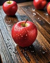 Red delicious apples with water droplets on beautiful wooden table