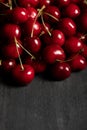 Red delicious cherries scattered on wooden