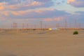 Red Desert Safari and and high voltage metal post in the industrial estate. Electricity tower in power energy concept in Dubai Royalty Free Stock Photo