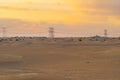 Red Desert Safari and and high voltage metal post in the industrial estate. Electricity tower in power energy concept in Dubai Royalty Free Stock Photo