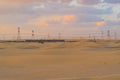 Red Desert Safari and and high voltage metal post in the industrial estate. Electricity tower in power energy concept in Dubai Royalty Free Stock Photo