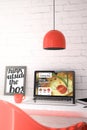 Red desktop with laptop showing cooking blog