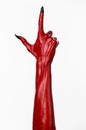 Red Devil's hands with black nails, red hands of Satan, Halloween theme, on a white background, isolated